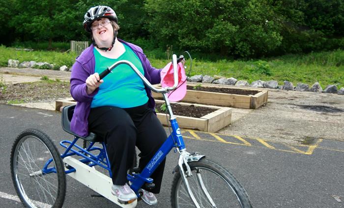 Woman on a trike enjoying cycling